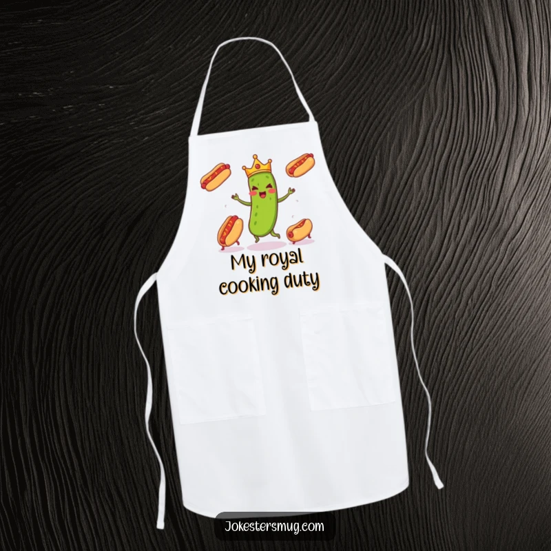 Funny pickle wearing a tiny crown enthusiastically juggling three runaway hot dogs, a humorous kitchen accessory on this funny apron.