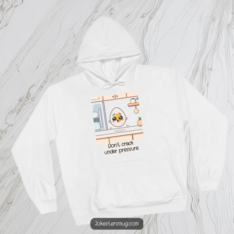 Funny Egg Hoodie: A startled egg with wide eyes rolls off a kitchen counter. Cozy and humorous funny gift.
