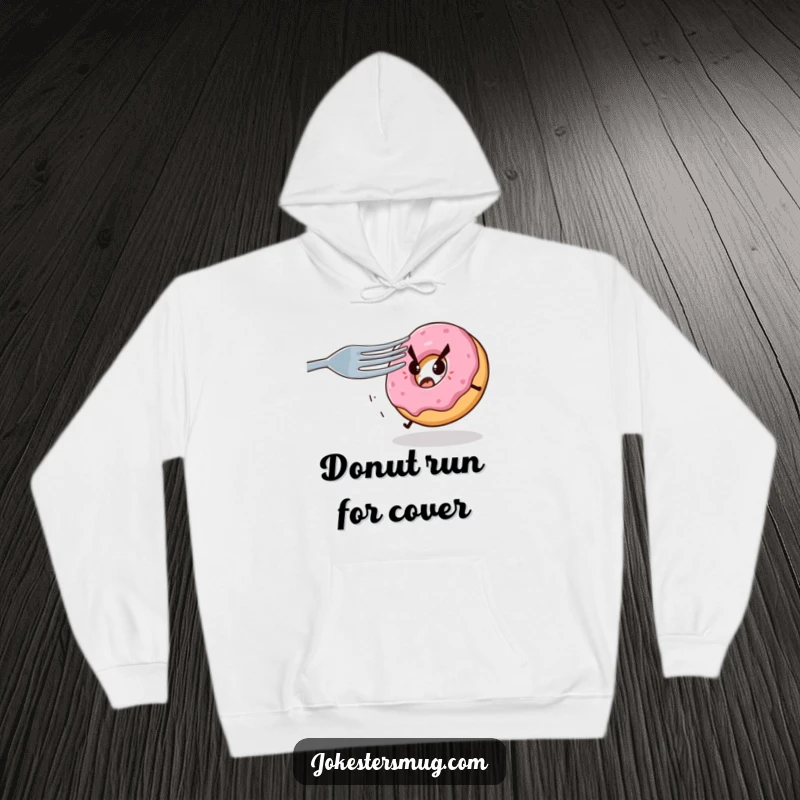 Funny hoodie graphic of a nervous donut fleeing from a giant, sharp fork with sinister eyes, a humorous and relatable depiction of fear.