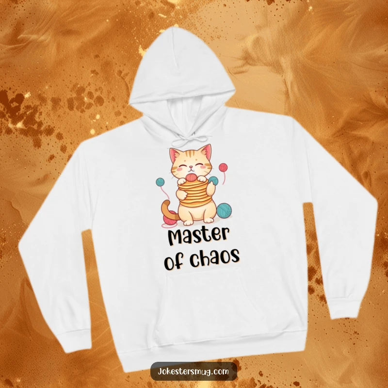 Funny cat wearing a hoodie, juggling pancakes and yarn, cozy and humorous design for winter, a great funny gift.