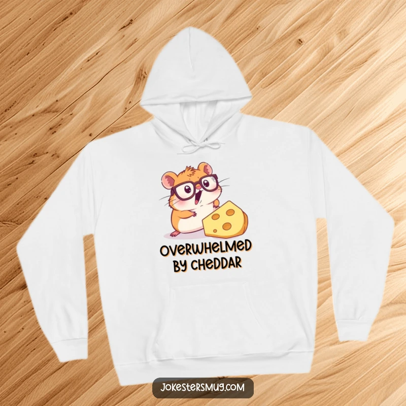 Funny hoodie depicting a wide-eyed hamster wearing big glasses, stumbling dramatically over a massive piece of cheese, full of slapstick humor.