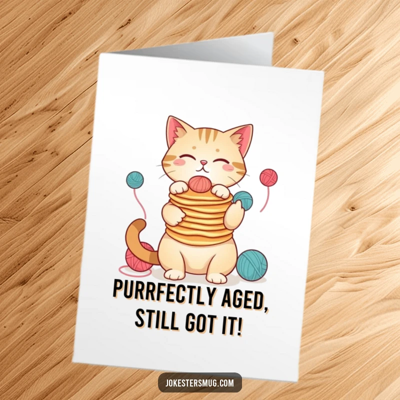 Funny free printable birthday card: A chaotic cat hilariously juggles pancakes on its nose while playing with yarn.