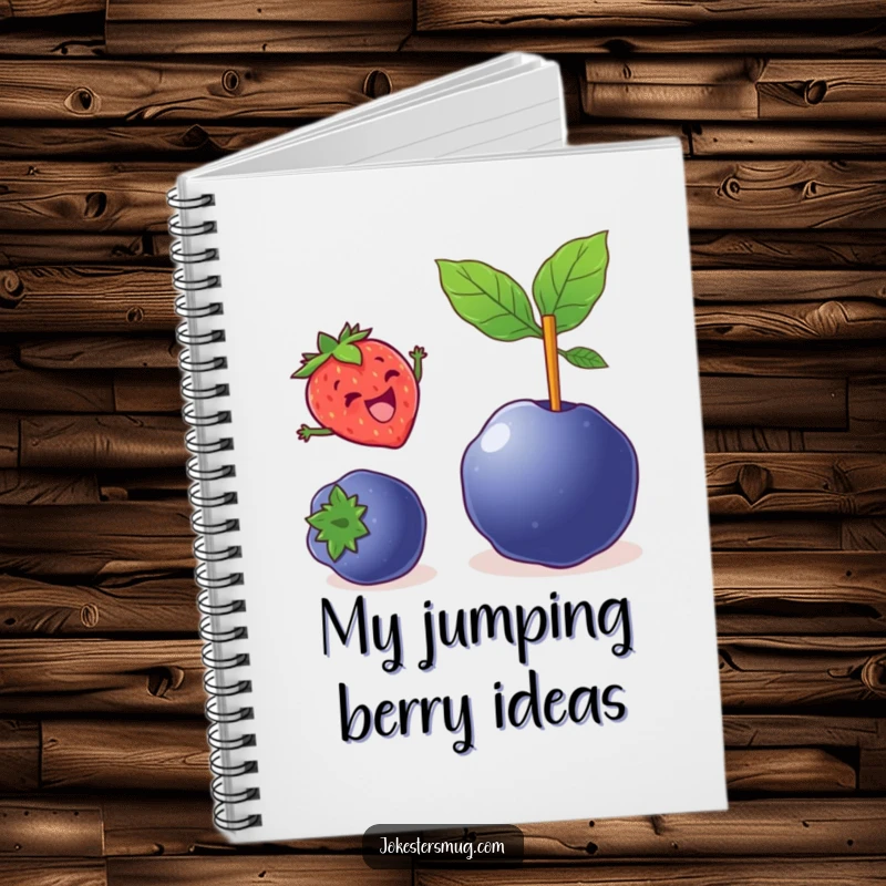 Funny notebook cover with a delighted strawberry pole vaulting over a large blueberry, a useful and humorous item.