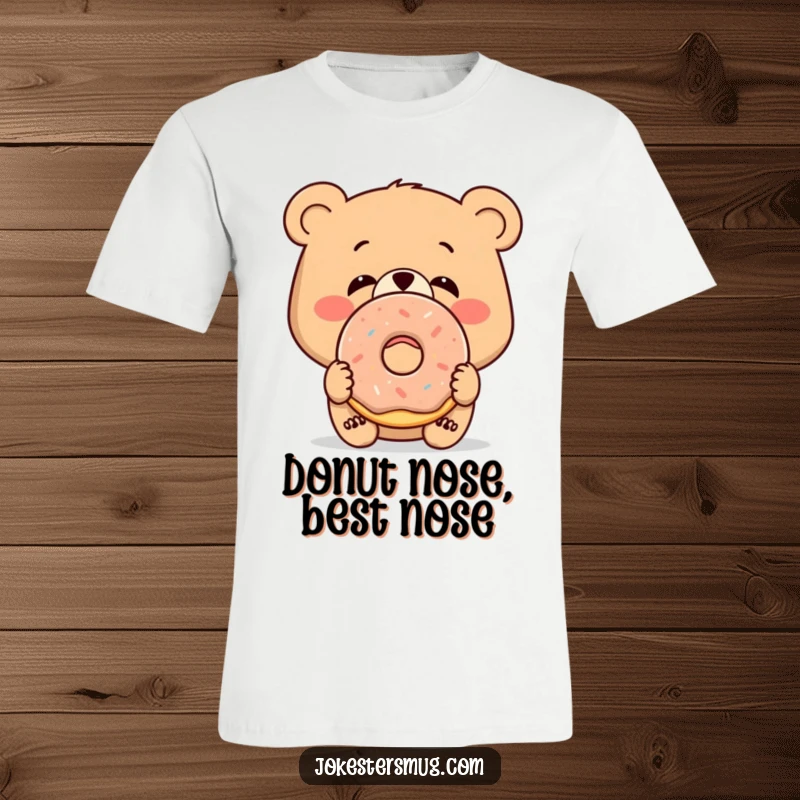 Funny t-shirt print of a bewildered bear with a donut stuck to its nose, perfect for treat lovers.