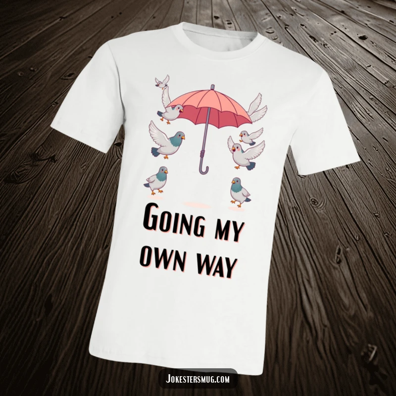 Funny surprised pigeons attempting to fly in opposite directions from a single, tiny umbrella, a humorous scene on this funny t-shirt.