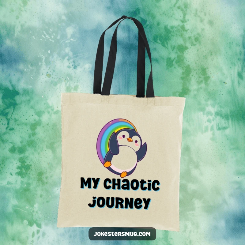 Funny tote bag showcasing a penguin sliding down a rainbow and comically landing upside down with a surprised expression, ideal for carrying fun.